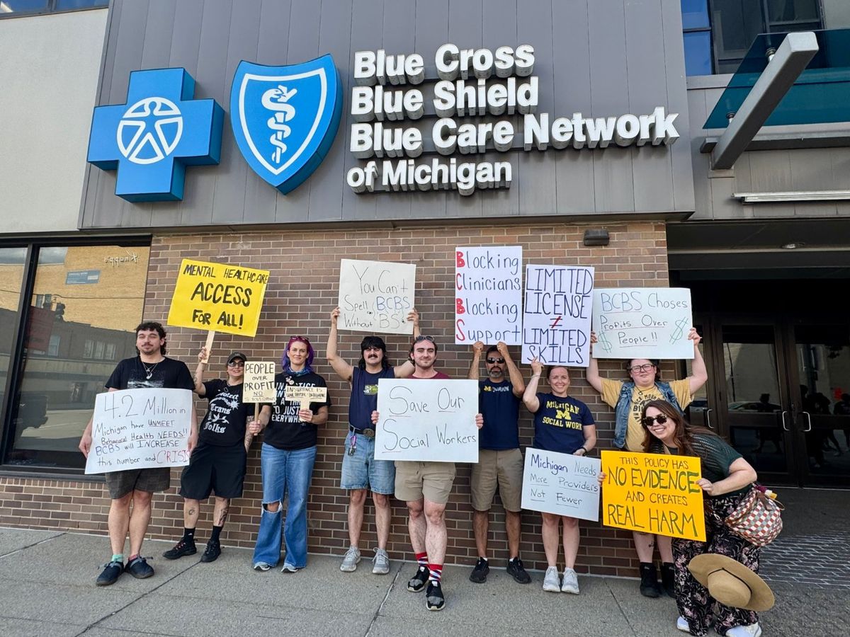 Counselors and supporters gathered with signs outside Blue Cross Blue Shield of Michigan headquarters in Detroit on August 21, 2026.
